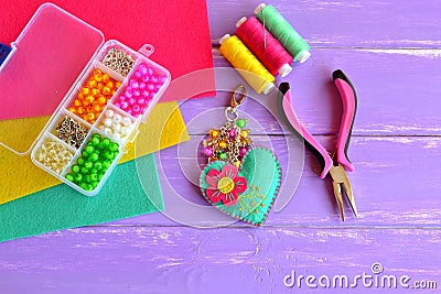 Homemade keychain felt embellished with beads. Box with beads, pliers, felt sheets, needle, thread Stock Photo