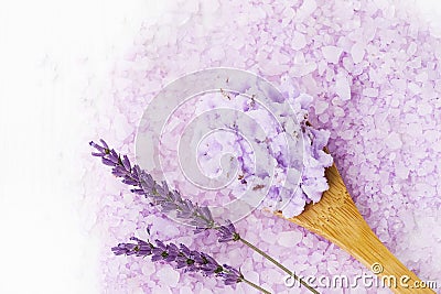 Homemade lavender body scrub in wooden spoon on lavender bath salt background. Top view, copy space. SPA concept Stock Photo