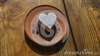 Homemade lavender ice cream in in the shape of a heart in rural clay plate decoration blueberry. Creamy vegan lavender Stock Photo