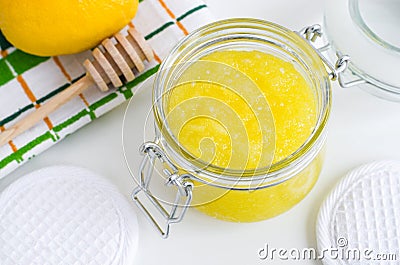 Homemade lemon and honey facial mask sugar scrub in the glass jar. DIY citrus beauty treatments and spa recipe. Stock Photo