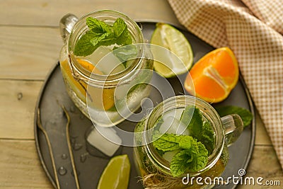 Homemade lemonade with lime, mint in a mason jar on a wooden rustic table. Summer drinks Stock Photo