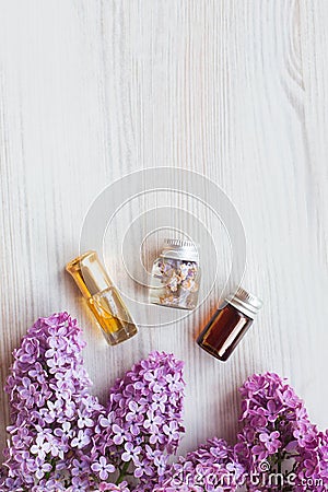 Homemade lilac cosmetics, care products, Small jars with infusion water of lilac, essential oil, Stock Photo