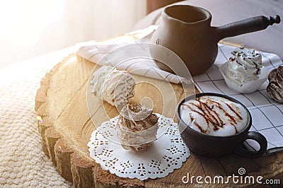 Homemade marshmallow zephyr with clay cup of cappuccino with sunny rays Stock Photo