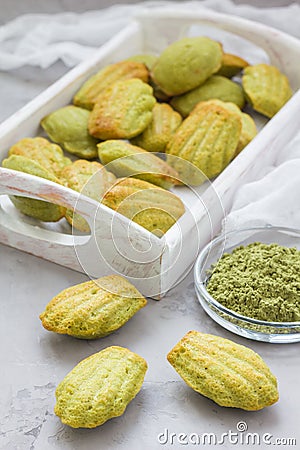 Homemade matcha green tea madeleines on the table and in wooden tray Stock Photo