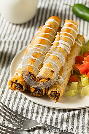 Homemade Mexican Chicken Flautas with Crema Stock Photo