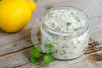 Homemade mint exfoliating scrub scalp peeling, bath salt, foot soak with sugar, chopped mint leaves Stock Photo