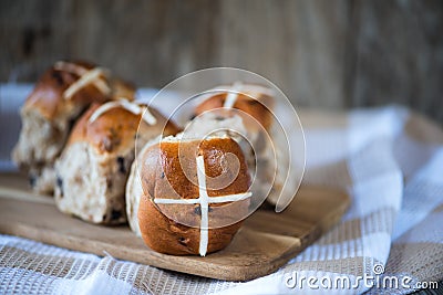 Homemade mixed fruit and cinnamon easter hot cross buns Stock Photo