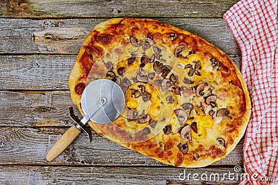 Homemade mushrooms pizza with cutter and towel Stock Photo