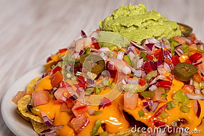 Homemade nachos with vegetable salad hash and guacamole. Closed image with copy space Stock Photo