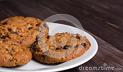 Homemade oatmeal cookies on a white plate. Wooden background Stock Photo