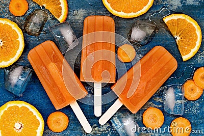 Homemade orange and carrot natural juice popsicles with turmeric, honey and ginger. Stock Photo