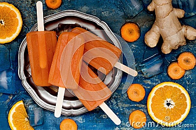 Homemade orange and carrot natural juice popsicles with turmeric, honey and ginger. Stock Photo