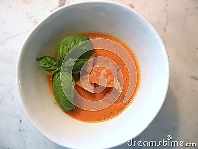 Homemade Organic homegrown Heirloom tomato soup with crouton and fresh basil Stock Photo