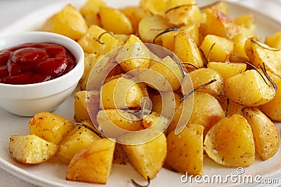 Homemade Oven Roasted Potatoes with Ketchup on a Plate, side view Stock Photo