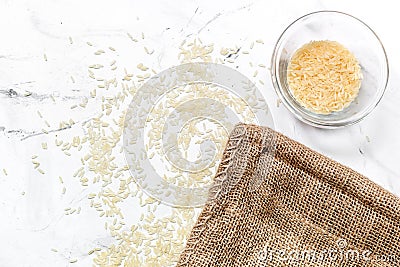 Homemade paella ingredients composition with rice in bowl on white table background top view mock-up Stock Photo