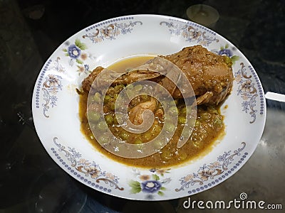 homemade Pakistani chicken curry with pea in traditional plate Stock Photo