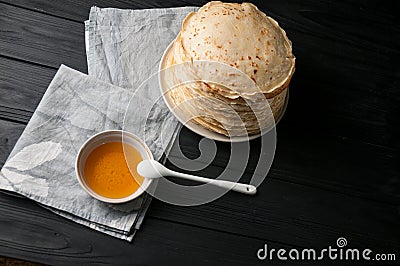 Homemade pancakes with honey and walnuts, vintage white plate, dipper, dark wooden table. Stock Photo