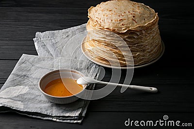 Homemade pancakes with honey and walnuts, vintage white plate, dipper, dark wooden table. Stock Photo