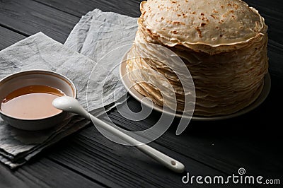 Homemade pancakes with honey and walnuts, vintage white plate, dipper, dark wooden table. Stock Photo