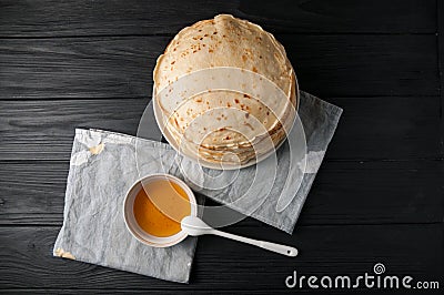 Homemade pancakes with honey and walnuts, vintage white plate, dipper, dark wooden table. Stock Photo