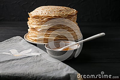 Homemade pancakes with honey and walnuts, vintage white plate, dipper, dark wooden table. Stock Photo