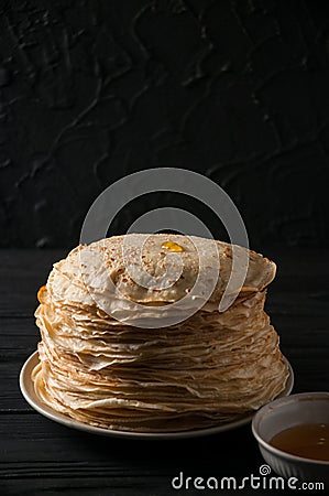 Homemade pancakes with honey and walnuts, vintage white plate, dipper, dark wooden table. Stock Photo
