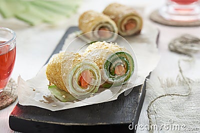 Homemade pancakes rolls with red fish, soft cheese and cucumber Stock Photo