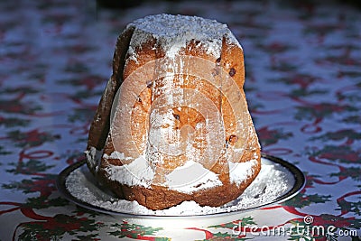 Homemade panettone closeup on beautiful christmas tablecloth. Sweet bread served as dessert on table Stock Photo