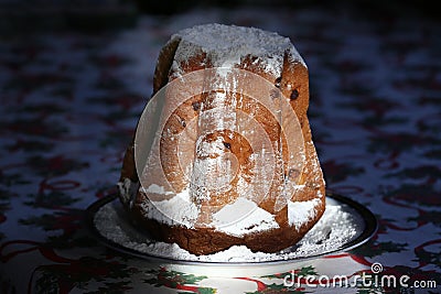 Homemade panettone closeup on beautiful christmas tablecloth. Sweet bread served as dessert on table Stock Photo