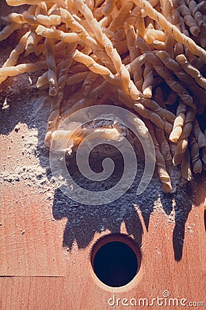 Homemade pasta lying on a wood cutting board Stock Photo