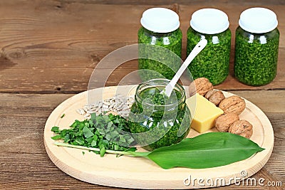 Homemade pesto in jars on rustic wooden table Stock Photo