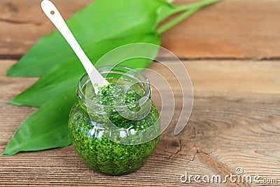 Homemade pesto in jars on rustic wooden table Stock Photo