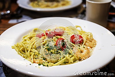 Homemade pesto linguine pasta with sauteed prawns in Alfredo sauce Stock Photo