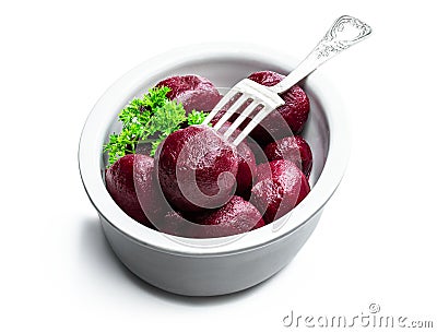 Homemade pickled baby beetroot in clay pot on black stone background Stock Photo
