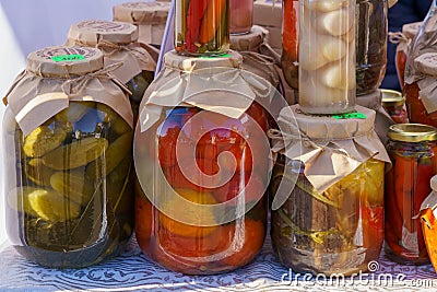 Homemade pickles in jars on the counter of the city fair. November 11, 2021 Balti Moldova Editorial Stock Photo