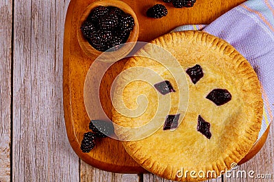 Homemade pie with blackberries on wooden background. Top view Stock Photo