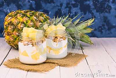 Two jars of homemade pineapple yogurt. A concept of light and healthy desserts. Stock Photo