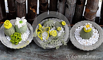 Homemade product for home decoration, group of succulent, cactus crochet in cement pot on wooden background Stock Photo