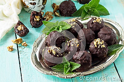 Prune balls in chocolate with hazelnut filling. Copy space Stock Photo