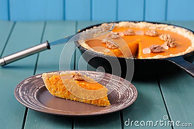 Homemade pumpkin pie with wallnuts on turquoise wooden table Stock Photo