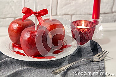 Homemade red caramel coating apples on a sticks for Christmas and New Year Stock Photo