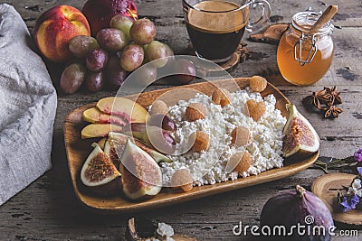 Homemade ricotta cheese , raspberries,figs , peach, honey. Healthy breakfast, coffee. on serving board over rustic wooden Stock Photo