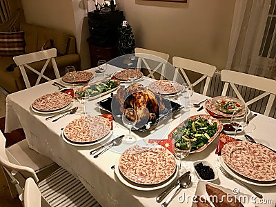 Homemade Roasted Thanksgiving Day Turkey with all the Sides at Dinner Table. Stock Photo