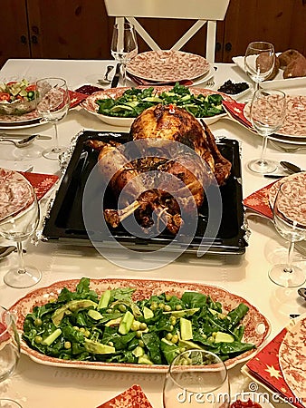 Homemade Roasted Thanksgiving Day Turkey with all the Sides at Dinner Table. Stock Photo