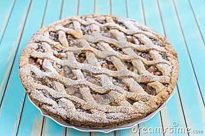 Homemade rustic apple tart pie on dish over wooden turquoise background Stock Photo