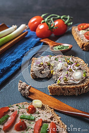 Homemade Rustic Pate on Bitten Slice of Bread with Fresh Vegetables Stock Photo