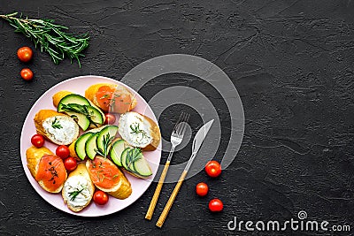 Homemade sandwiches with french baguette, salmon, cheese and vegetable on black background top view mock-up Stock Photo