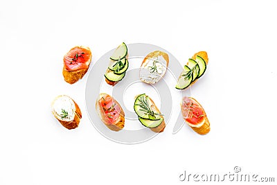 Homemade sandwiches with french baguette, salmon, cheese and vegetable on white background top view Stock Photo