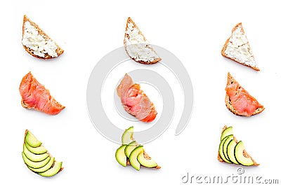 Homemade sandwiches with french baguette, salmon, cheese and vegetable on white background top view Stock Photo