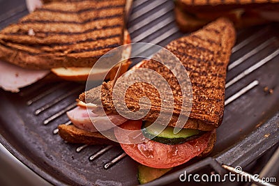 Homemade sandwiches lie on the groa grill Stock Photo